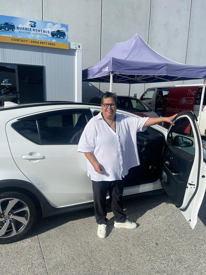 Happy Bubble Rentals customer with their rental car