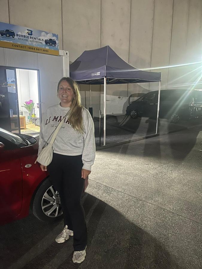 Happy Bubble Rentals customer with their rental car