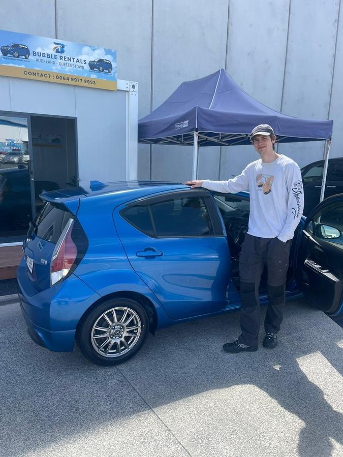 Happy Bubble Rentals customer with their rental car