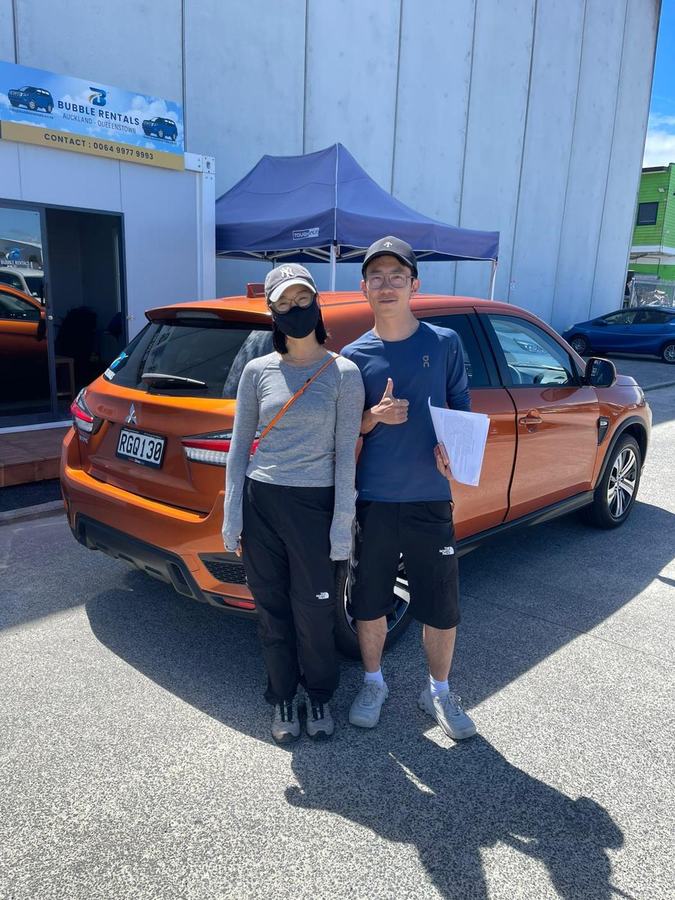 Happy Bubble Rentals customer with their rental car