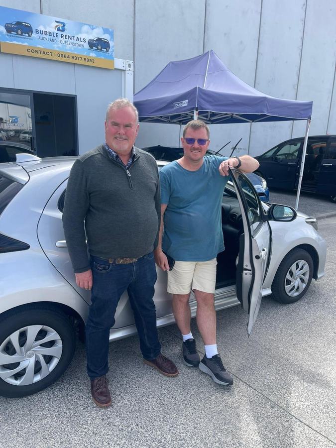 Happy Bubble Rentals customer with their rental car