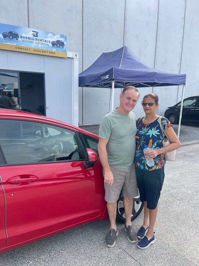 Happy Bubble Rentals customer with their rental car