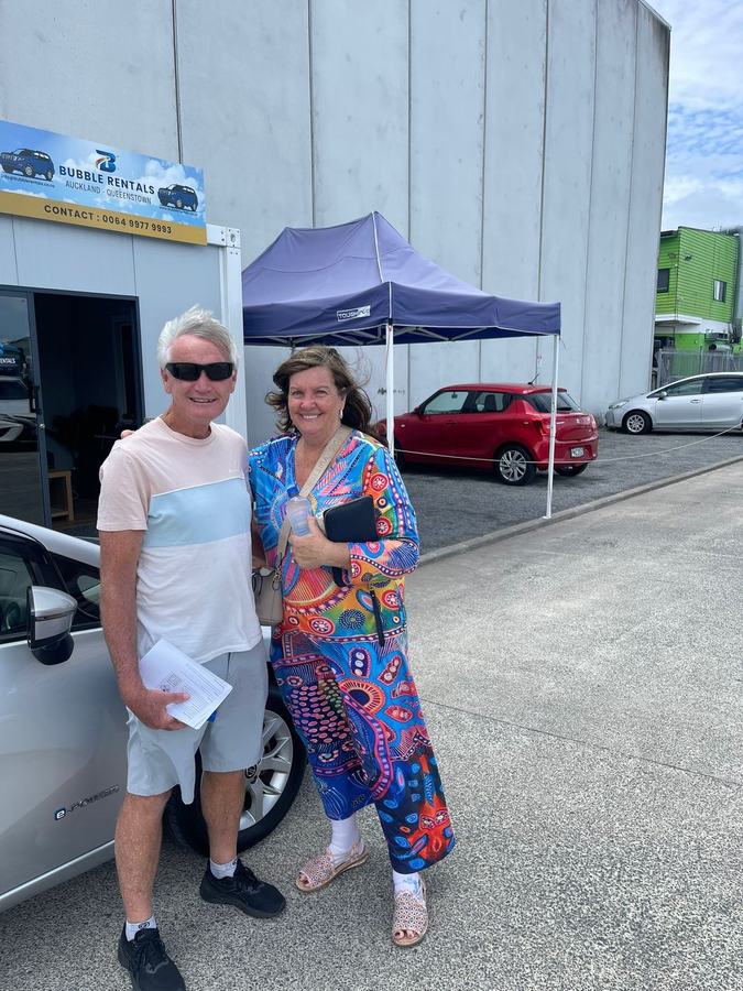 Happy Bubble Rentals customer with their rental car