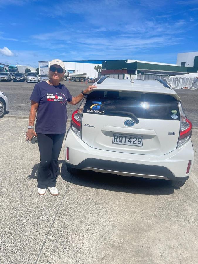 Happy Bubble Rentals customer with their rental car