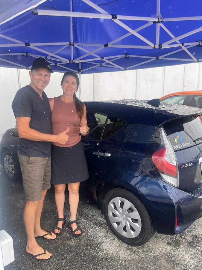 Happy Bubble Rentals customer with their rental car