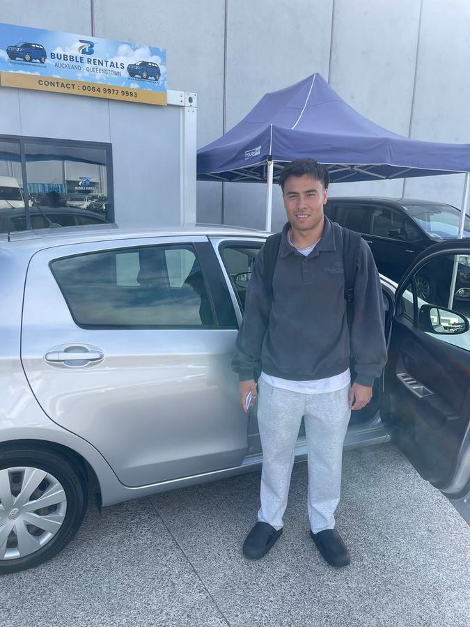 Happy Bubble Rentals customer with their rental car