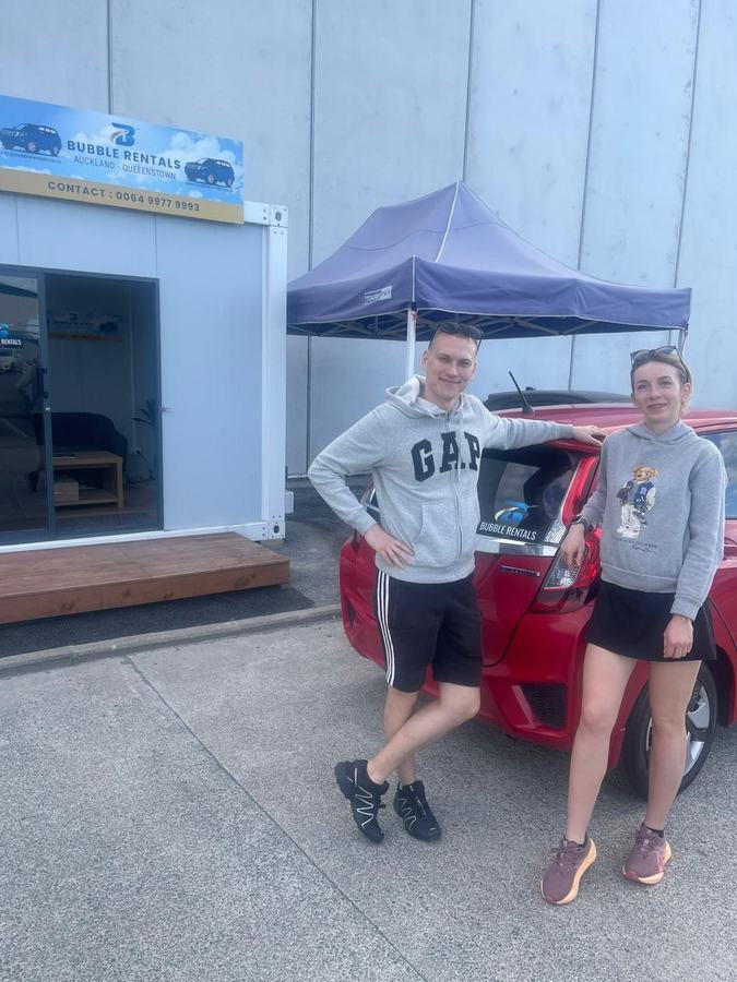 Happy Bubble Rentals customer with their rental car