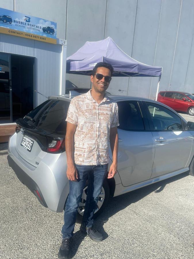 Happy Bubble Rentals customer with their rental car
