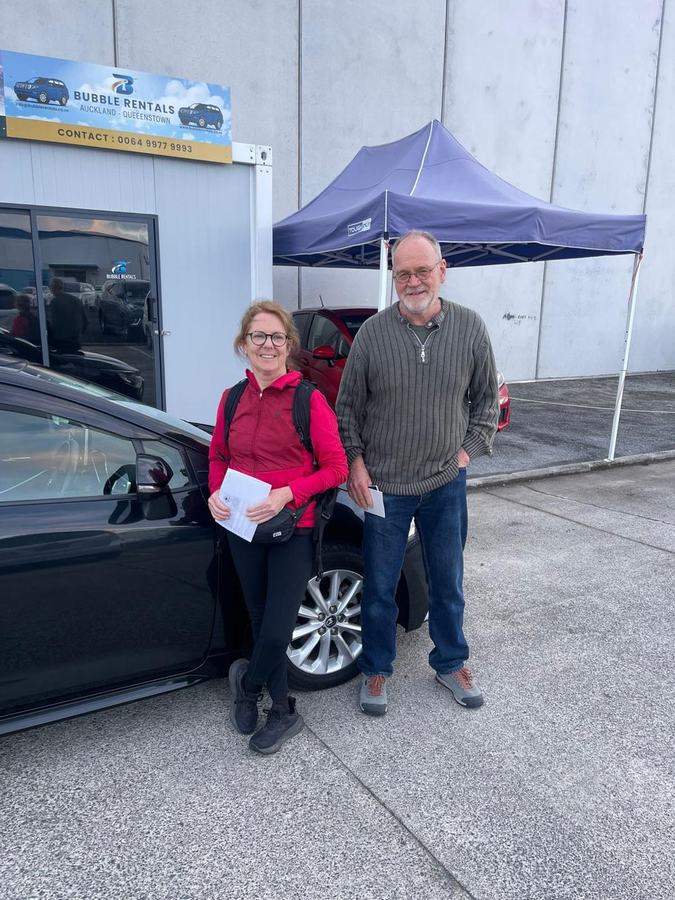 Happy Bubble Rentals customer with their rental car